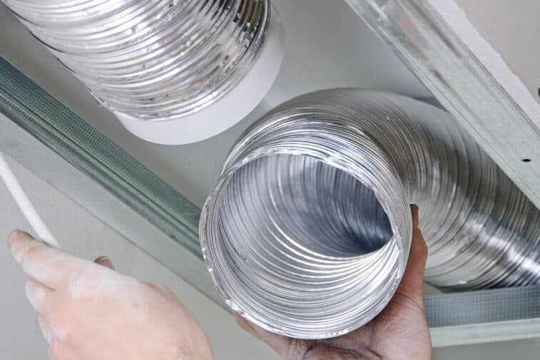 Technician cleaning a dryer vent